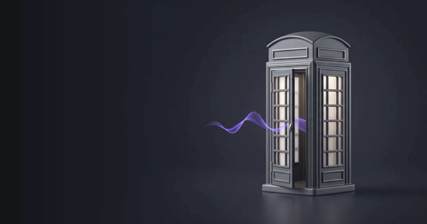 A miniature British telephone kiosk in graphite, lit from inside, with a sound wave curling out of the door